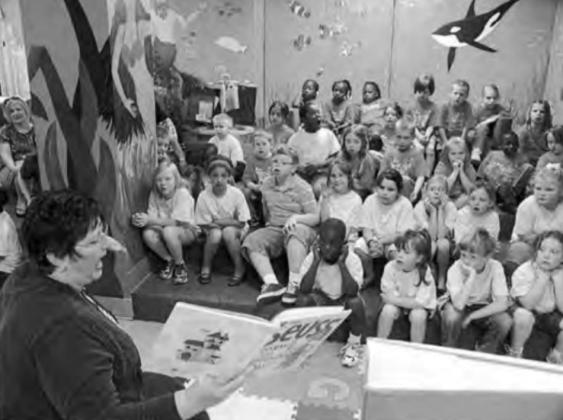In her first year as library director in 2006, Jackie reads to children in the new undersea marine and “Yellow Submarine” world of the library’s basement. Friends gather to remember their library director Jackie Icenhower