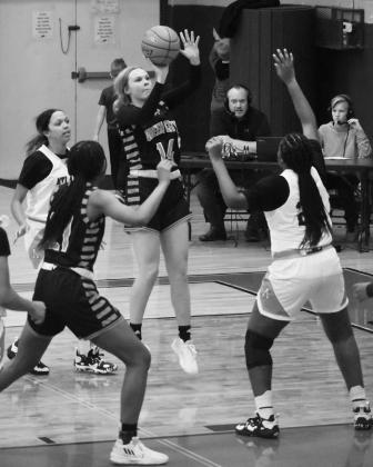 Queen City’s Lauren Carrell puts up a shot over an Atlanta defender. Photo by PHYLLIS WARREN AMS boys sweep Paul Pewitt