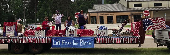 The Kildare Community Center America-themed float Wildflower Trails Parade in Linden took first place. Pictured during the Hughes Springs parade where they took third place, are, above from left, Mary Echols, Lynda Adcock, Niccqueta Varmall, Rhonda Whatle