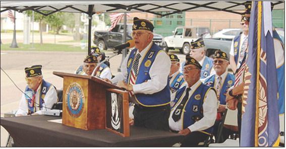 American Legion Post 258 Commander Mike Steward addresses guests at the Memorial Day program held in downtown Atlanta. Below, American Legion Post 258 members retire the flag at Veterans Plaza and replace it with a flag donated by Gary Richardson. Photo b American Legion Post 258 Commander Mike Steward addresses guests at the Memorial Day program held in downtown Atlanta. Below, American Legion Post 258 members retire the flag at Veterans Plaza and replace it with a flag donated by Gary Richardson. Photo b