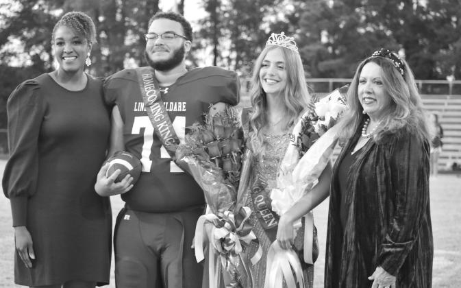LaToyia McGar, Homecoming Queen of 1999 and Sandra Skoogs representative for the Class of 1974 crown the Linden-Kildare king and queen. From left are: McGar, Dominique Mack, Evey Lansdale and Skoogs. Photo by Cassidy George LaToyia McGar, Homecoming Queen
