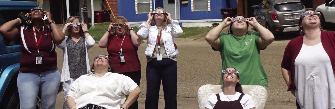 Here was a very common during the recent cosmic event. Office workers outside and with special sunglasses looking at the sun.These eight people were from the Cass County Shared Services organization on West Hiram.The professionals work with special educat Atlanta Public Library eclipse party