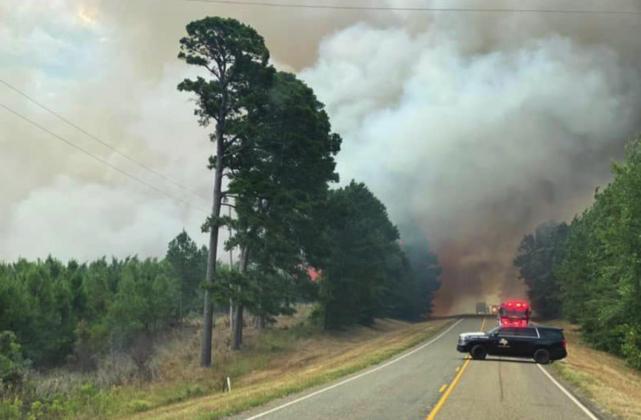 Smoke billows over the roadway in Cass County on the Cass 4439 Fire on July 29, 2022. Photo courtesy of C. Mayo. Credit: Texas A&M Forest Service. Large wildfire burns 50 acres in Linden
