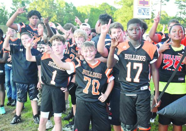 Photo by PHYLLIS WARREN The Little Bulldogs and the Mini Cheerleaders were a definite highlight last Friday night as they ran out with the football team and cheered them on during the first quarter