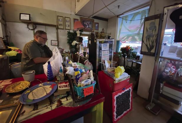 An Estate Barn worker wraps up breakables and sacks them up while totaling out a customer’s tab. Rain or Shine,Holiday Shoppers Show Up For Deals