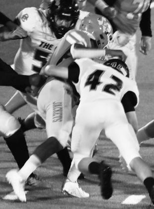 Queen City defender Spencer Warren makes a nice tackle on a Yellowjacket ball carrier. Article Image Alt Text