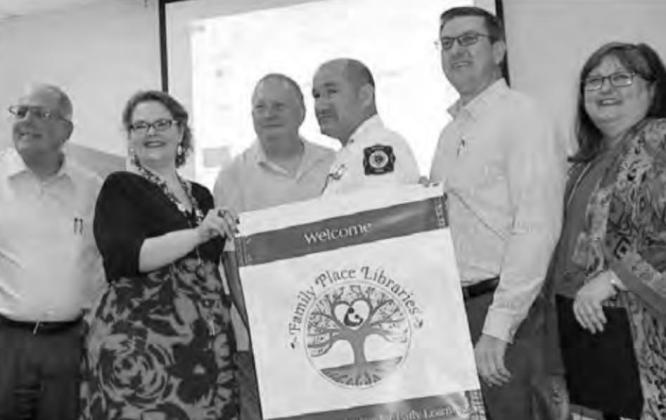 In one of its biggest moments in 2018, the Atlanta Public Library receives national designation as a Family Place Library. There to celebrate are, from left: Atlanta City Manger David Cockrell, library staffer Randi Strutton, city council member Ken Paddi Friends gather to remember their library director Jackie Icenhower