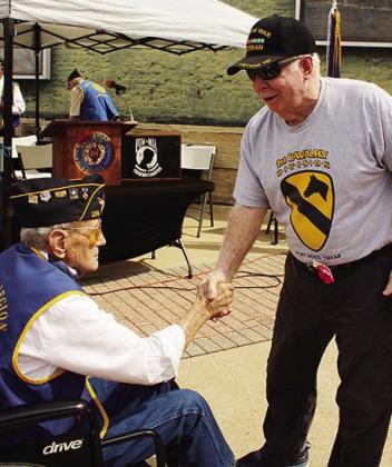 Gordon Pynes shakes hands with veteran John Fox after the Memorial Day program. Photo by MARTY ALEXANDER Gordon Pynes shakes hands with veteran John Fox after the Memorial Day program. Photo by MARTY ALEXANDER