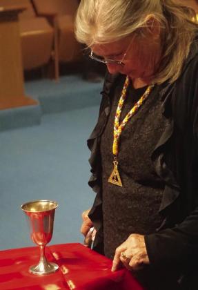 The golden cup symbolizes charity and hospitality and is watched over by Eastern Star member Cathy Zachry. The cup also helps members organize their thoughts for prayer. Linden Order of Eastern Star