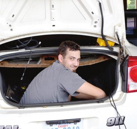 A contractor installs the new WatchGuard videocam system in an APD cruiser. (Photo by Kate Stow) APD goes HD
