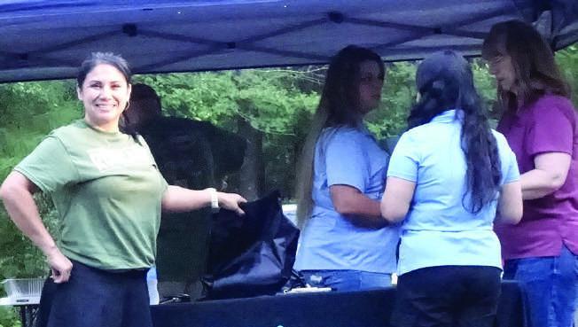 Tanya Beers, owner of Caffe Creme in Atlanta, waits to speak with Red River Credit Union employees who are sponsoring a table at the 4th annual Trail Grinder run.The RRCU was one of the first sponsors of the benefit event. Tanya Beers, owner of Caffe Creme in Atlanta, waits to speak with Red River Credit Union employees who are sponsoring a table at the 4th annual Trail Grinder run.The RRCU was one of the first sponsors of the benefit event.