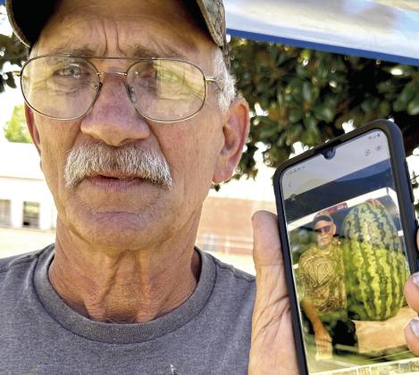 Ray Werline is proud to have this cell phone picture of him with one of his biggest prize winning watermelons.This one, grown several seasons ago, weighed in at 164 pounds. Werline melons