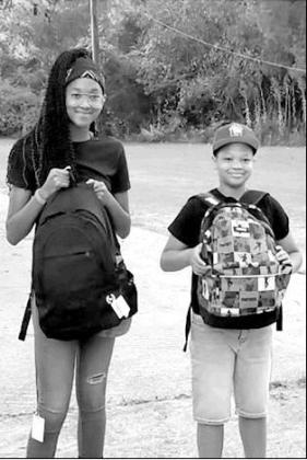Atlanta students Kym Sheppard, eighth grade, and Hardy Sheppard, third grade, take a moment for a first day of school photo. Article Image Alt Text