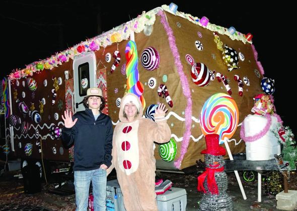 t Pamela Milligan of Queen City has made a special effort to be the Gingerbread Woman who has run away to live for awhile as a cookie in her cookie house. Her son Mitch Stone is enjoying the evening at Rocky Point Park, too. Milligans create festive display at Rocky