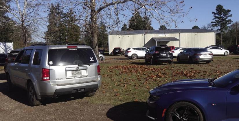 The cars are lined up Saturday morning before the Fairview Community at 606 County Road 1625, Linden,TX.The occasion is a Christmas Gift of food. Some 125 recipients will be served in the annual Christmas drive. Fairview Corporation
