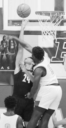 Queen City’s Reginald Harrison goes up for a rebound against a Paul Pewitt defender. Photo by PHYLLIS WARREN McLeod slams Harleton