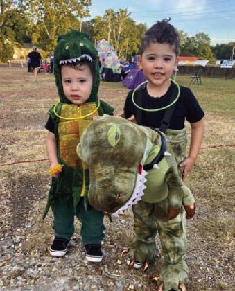 Dinosaur brothers, Lincoln, 1 1/2, and Miles, 3 get ready to start the Monster Mile Saturday Glow Run on Saturday Hiram haunted by glowing goblins, ghouls