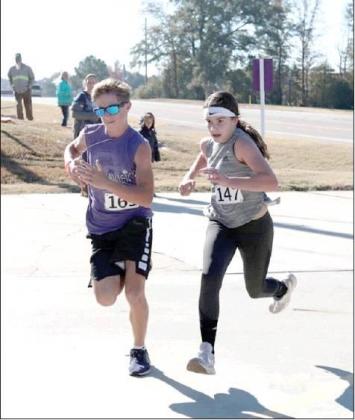 Courtesy photo Kaden Satterfield and Kendall Fant head to the finish in the 22nd Annual Turkey Trot 5K race. Article Image Alt Text