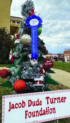 The Christmas tree above which is chosen first place decoration recalls the memory of Jacob “Dude” Turner, a youthful community member killed a car accident in 2010 and who is now remembered by several activities. Linden square christmas