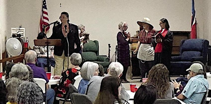The audience is carefully watching the dinner theater mystery on stage. This is because everyone, evening the audience, is a suspect. The audience is carefully watching the dinner theater mystery on stage. This is because everyone, evening the audience, is a suspect.