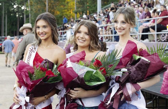 Kailee Ammons, Boston Graf and Emma Allen take a photo on Homecoming night.