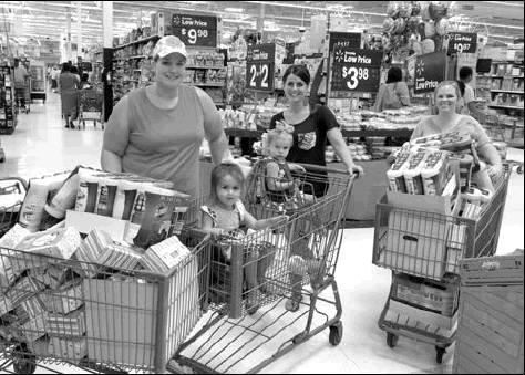 Erin Coats, Carly Rowell and Sara McLaurin prepare for this year’s backpack giveaway. Article Image Alt Text