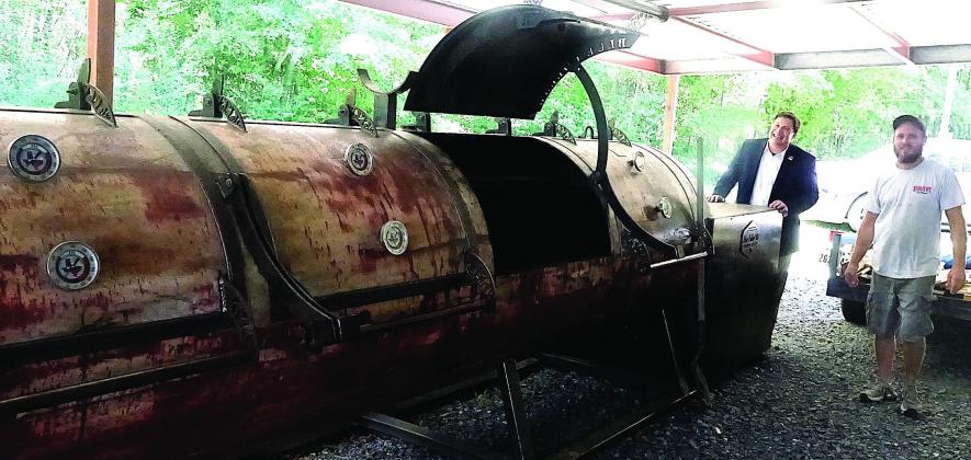 Linden City Manager Lee Elliott, left, and Stryk’s Pit BBQ owner Travis Stryk are standing by the heart of the business, i.e., its major smoker which prepares the meat. From barbecue to baseball,Texas style