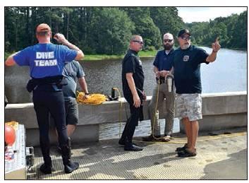 Eric Tutt (back) & Chris Sutherland, divers, are joined by Avinger Fire Dept and the Cass County Sheriff’s Office. Article Image Alt Text