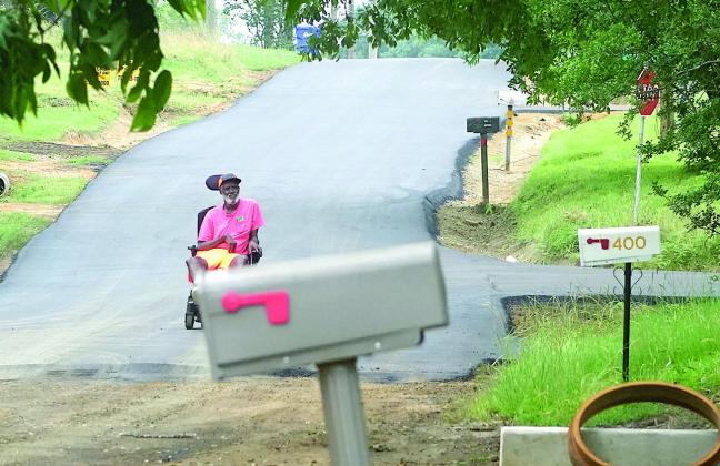 t Willie Linwood definitely has an opinion as he guides his motorized wheelchair down Frazior Street.The new pavement and smooth ride are “about time,” he says of the town’s street paving project. He’s headed to the grocery store. Linden pavement