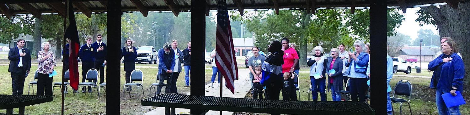 Linden-Kildare student Ja’Maiya Mack is singing the National Anthem as a solo at the Texas Arbor Day celebration in the Linden City Park Nov.1.Members of the community are joining in and holding hands over hearts. Arbor Day