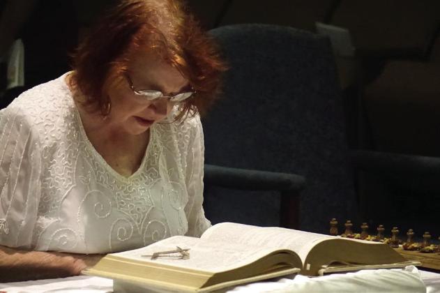 Carole McGee is reading the Bible for the installation of officers for the Linden Order of the Eastern Star Chapter 576. Note the square and compass symbols of Masonry which,with special permission, can be placed on the Bible pages. Linden Order of Eastern Star
