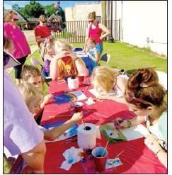 903 Artisans and Flip N Cheer’s Krystal Dawn paints Watercolors at Woods Park with the kiddos on July 3. Article Image Alt Text