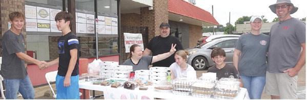 Clowning around while waiting on customers are these members of Sand Hill Assembly of God Church near Bloomburg. They are holding a bake sale at Price Hardware to send youth to summer camp.They are, from left, Remington Dawson, Craig Johnson, Leah Johnson Clowning around while waiting on customers are these members of Sand Hill Assembly of God Church near Bloomburg. They are holding a bake sale at Price Hardware to send youth to summer camp.They are, from left, Remington Dawson, Craig Johnson, Leah Johnson