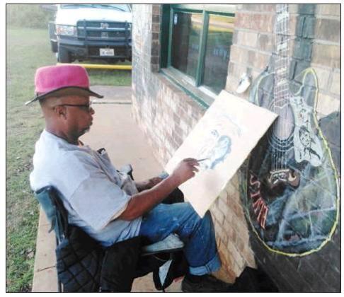Photos by JAMIE JEANS Shinar, who has already painted murals across downtown Atlanta, put a splash of color on the outside and inside walls of the Country Music Store. Entertained at the Country Music Store