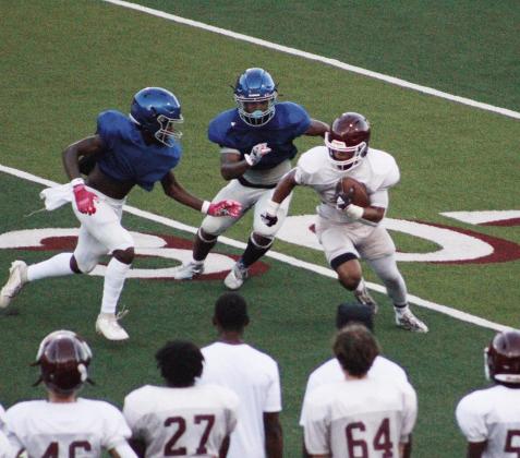 Rabbit ball carrier Jayden Riley tries to cut around the defense during the Rabbs’ scrimmage with Hooks last week. It’s the most wonderful time of the year
