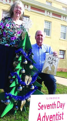 Linden Seventh-Day Adventist Church Pastor Gary Howard and his wife have come to decorate and add to the Christmas tree the church is sponsoring on the Cass County Courthouse lawn. Linden square christmas