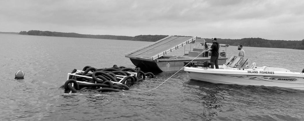 TPWD inland fisheries crew deploy a series of “Georgia Cubes” as part of an artificial fish habitat project recently completed on Toledo Bend.The project included 200 structures and was funded by the Sabine River Authority. (SRA Photo) FISH HOTELS