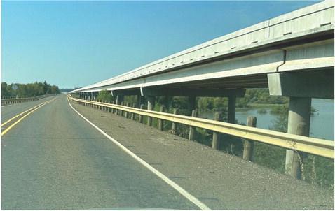 u This photo shows the new and taller State Highway 8 bridge at the right while the old bridge and highway on which the car is traveling is at the center.The striking feature is that the old bridge and road will be completely gone when work is completed i R. H. Hubbard Bridge work