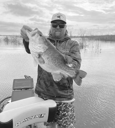 Fishing guide Jason Conn displays the 9.04 pounder he caught at Bois d’Arc Lake on April 24.TPWD fisheries scientists are doing genetics testing on scale samples from the fish to determine if it is one of the 2,000 plus advanced growth Toyota ShareLunke TESTING NEW WATER