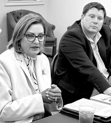 Jennifer Harland, SWEPCO External Affairs Manager, is speaking to the Aug. 10 meeting of the Cass County Consortium. Director of the consortium Lee Elliott of Linden is at right. SWEPCO presentation for Consortium