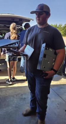 Weston Huett helps unload electronics for recycling. Weston Huett helps unload electronics for recycling.