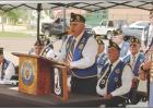 American Legion Post 258 Commander Mike Steward addresses guests at the Memorial Day program held in downtown Atlanta. Below, American Legion Post 258 members retire the flag at Veterans Plaza and replace it with a flag donated by Gary Richardson. Photo b