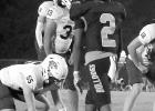 Grace Community School players in blue and white are stacked on defense against the Queen City offense.