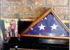The folded flag and a photo of Donald sit on the fireplace mantle in their home they bought in the 80s. The folded flag and a photo of Donald sit on the fireplace mantle in their home they bought in the 80s.