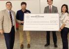 Queen City ISD educator Joe Thompson, second from left, and high school principal Janice McMellon receive a check from members of the Texas Workforce to train 70 welders in partnership with Texarkana College.
