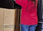 Olivia Beauchamp places an e-waste television into a box.