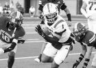 Rabbit running back Jayden Riley slices his way through New Boston’s defense in the Rabbs’ 33-7 win. Photo by Susan Lindsey