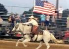 Zoe Scott galloping across the arena while proudly carrying the flag during the opening of this year’s rodeo. Article Image Alt Text